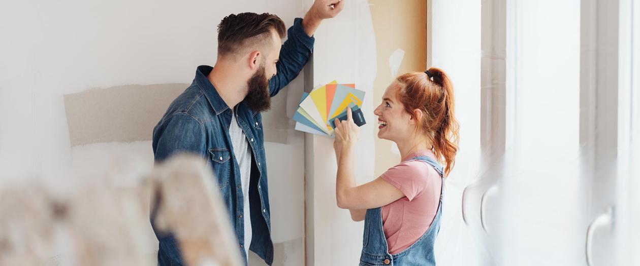 young couple picking paint for house